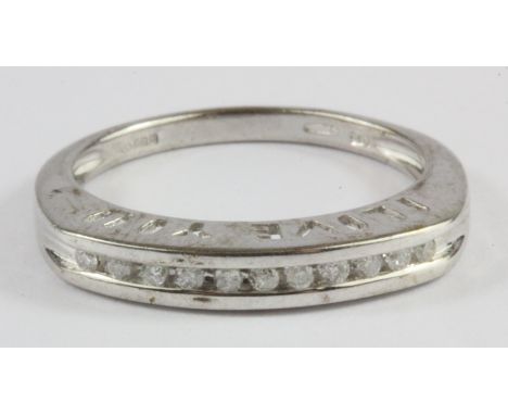 A 9ct white gold diamond set half eternity ring, (N.5).