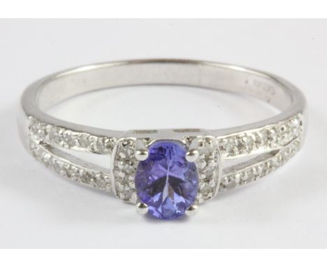 A 9ct white gold tanzanite and diamond set ring, (N).