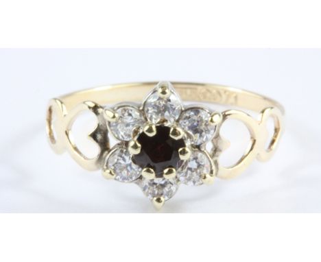 A 9ct yellow gold stone set cluster ring, (L).