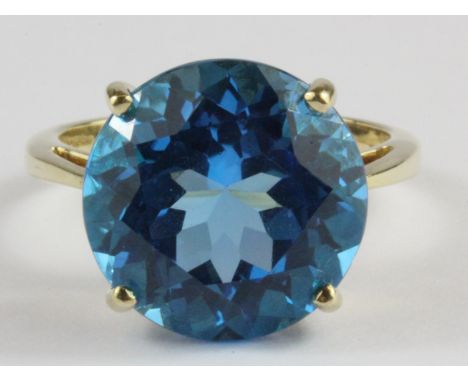 A 9ct yellow gold ring set with a large blue stone, (O).