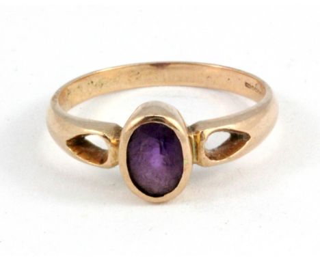 A 9ct rose gold ring set with an oval cut amethyst, (M.5).