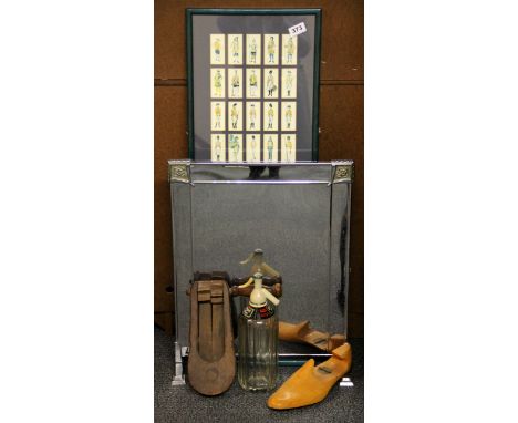 A frame of cigarette cards, fire screen, air raid rattle, etc.
