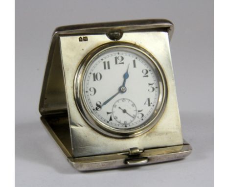 A heavy hallmarked silver travelling clock with engine turned decoration, case 7 x 5.5cm.