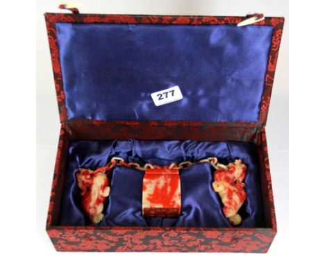 A rare boxed Chinese red soapstone seal with two dragons and chain carved from a single piece of stone, seal H. 7.5cm.