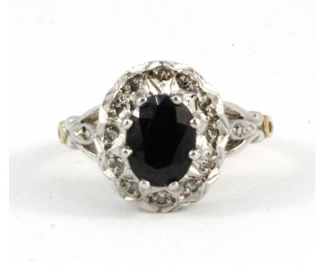 A 9ct diamond and sapphire cluster ring, (L).