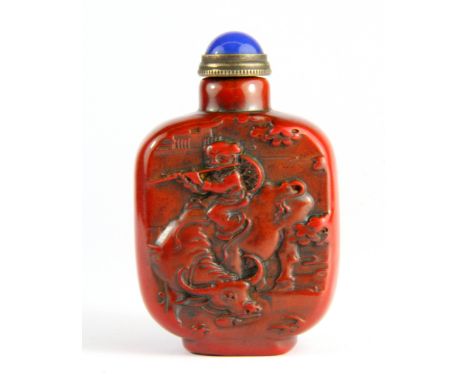 A Chinese carved red stone seal snuff bottle with gilt and hardstone stopper, H. 7cm.