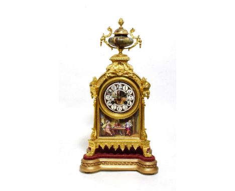 An Ormolu and Porcelain Mounted Striking Mantel Clock, circa 1890, porcelain urn shaped finial, porcelain painted cottage int