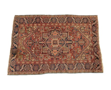 Heriz Carpet Iranian Azerbaijan, circa 1900 The terracotta field of angular vines around a typical medallion framed by spandr