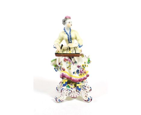 A Bow Porcelain Figure of a Musician, circa 1765, seated playing the zither, on a scroll moulded base, 18cmRestoration to rig