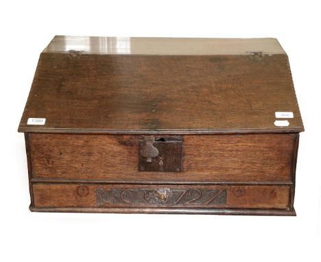 An 18th Century Carved Oak Bible Box, dated and initialled 1727 CC, the hinged lid with chip carved edge enclosing a small sh