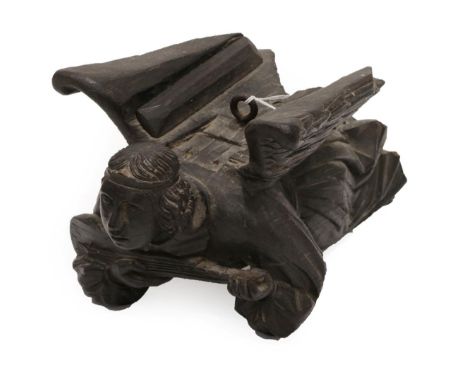 A Carved Oak Figure of an Angel, 19th century, modelled in flight whilst playing a musical instrument, 40cm long