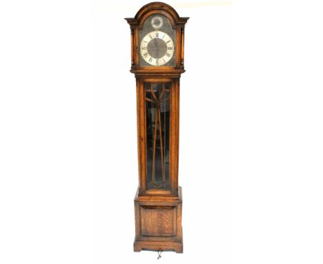 A 1930s oak longcase clock with Westminster St Michael and Withington chimes, the filigree and silvered dial set with Roman n