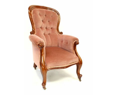 A Victorian mahogany fireside chair upholstered in pink button-back velvet, on carved cabriole legs, height 104cm. CONDITION 
