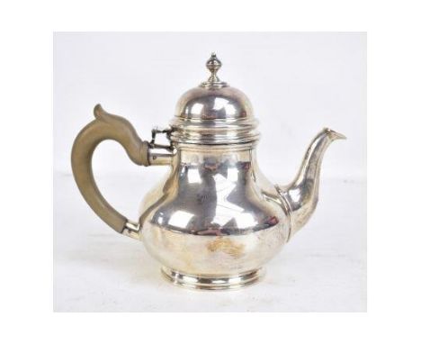 An Elizabeth II hallmarked silver teapot with cast finial on spreading circular feet, CJ Vander, London 1968, length 25cm, ap