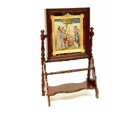 An Edwardian mahogany swing easel, the top enclosing a tapestried picture in a gilt frame, the whole on turned baluster suppo