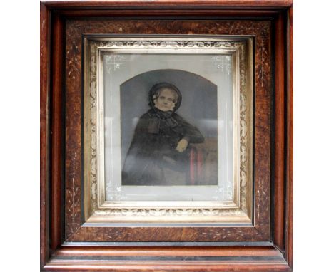 A negative print of an older lady wearing a bonnet within a mahogany decorative frame, print 23 x 18cm.