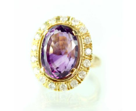 An 18ct yellow gold ladies' dress ring set with large amethyst and seventeen diamond surround, size U.