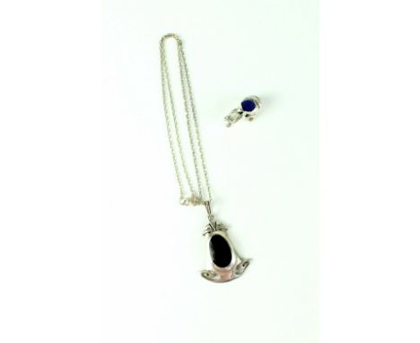 A small sterling silver pin cushion in the form of a frog with emerald coloured eyes and a Georg Jensen style silver and onyx