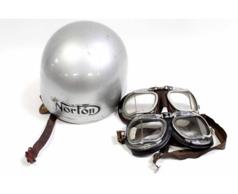 A vintage Norton motorcycle helmet in silver with company logo to the front, with leather and webbing to the inside together 