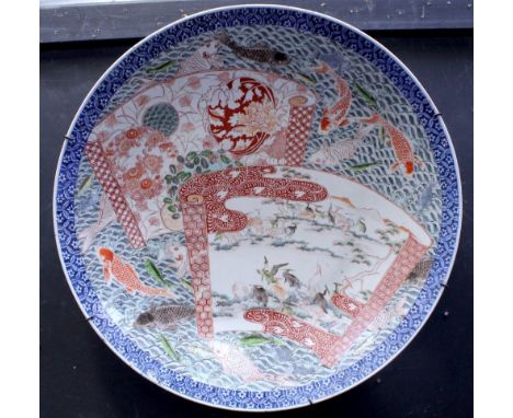 A large Japanese Meiji period Imari charger decorated with twin shaped panels within fish painted frame, diameter 61cm. CONDI