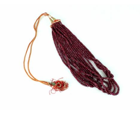 A ruby bead eight-row necklace, the graduated faceted beads on a woven-thread sliding knot clasp, the shortest string measuri