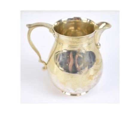 An Elizabeth II hallmarked silver cream jug with reeded detail, CJ Vander Ltd, London 1966, height 9.3cm, approx 6.7ozt/210g.