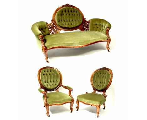 A Victorian walnut three-piece suite comprising three-seater settee, an open-arm fireside chair and matching fireside chair, 