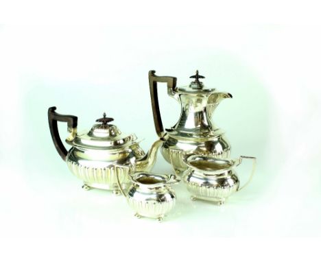 A George V four-piece hallmarked silver tea service with gadrooned decoration, Walker &amp; Hall, Sheffield 1912, combined ap