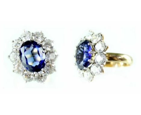 A 9ct yellow gold ladies' dress ring with central large blue stone with ten white stone surround, size X.