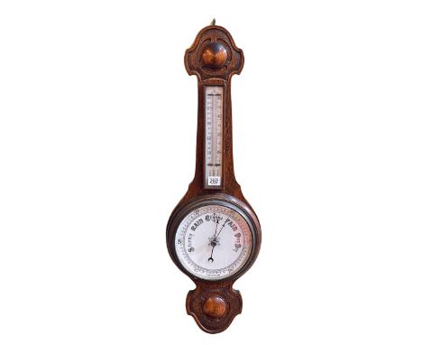 Oak barometer with enamelled dial.