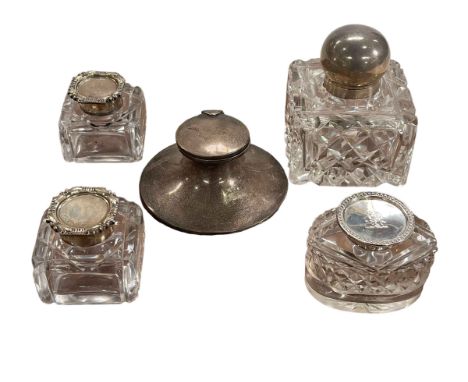 Silver inkwell and four silver topped glass inkwells.