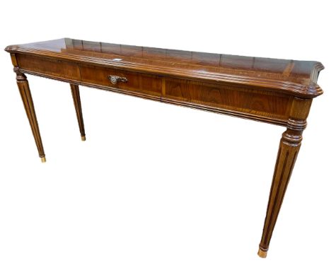 Rectangular walnut console table on turned reeded legs, 68.5cm by 138cm by 41cm.