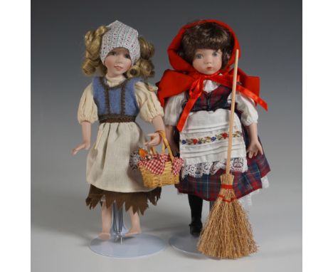 A collectible porcelain doll set from The Ashton-Drake Galleries featuring Cinderella and Little Red Riding Hood, both intric