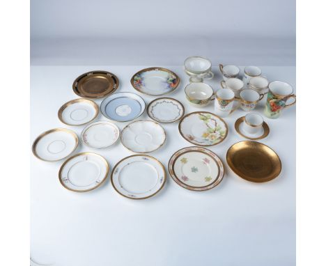 A refined collection of 24 antique and vintage porcelain tea and coffee pieces, featuring gilded accents and intricate hand-p