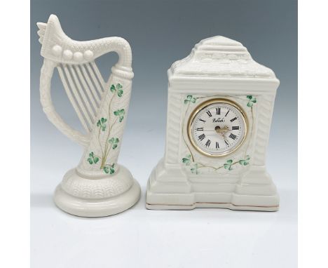 A charming set of Belleek figurines featuring a harp and a clock, adorned with shamrock motifs. Both pieces bear the Belleek 