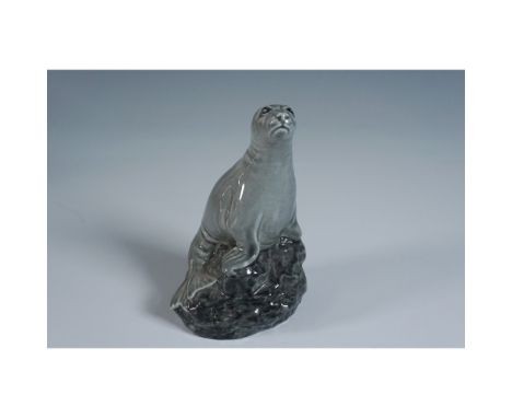A Beswick Sea Lion figurine, modeled as a Beneagles Scotch Whisky decanter by J. G. Tongue in 1981. The base features an insc