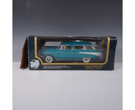 This 1:18 scale diecast model by Road Tough replicates the classic 1957 Chevrolet Nomad in a striking blue finish with silver