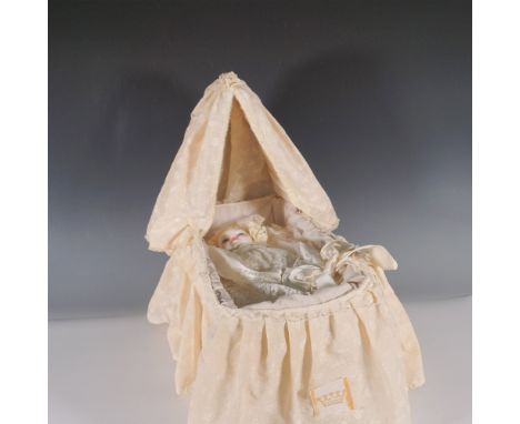 Commemorating the birth of Prince William of Wales on June 21, 1982, this exquisite porcelain doll by Royal Doulton is presen