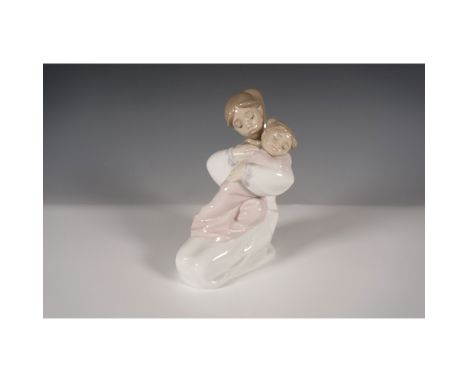 Nao by Lladro porcelain figurine "A Hug of Love", model 1467, depicting a young woman embracing a sleeping child. Handcrafted