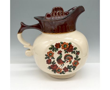 Cream colored pitcher with brown glazed spout and lid with center rooster art with flowers. McCoy USA mark.Issued: c. 1970Dim