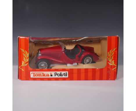 This Tonka Polistil diecast model features a classic MG TC roadster in a red finish with black interior detailing. The model 