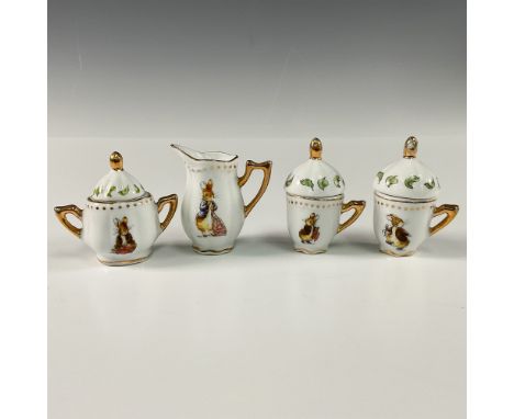 This charming collection of miniature porcelain cafe items showcases whimsical illustrations of Peter Rabbit and Benjamin Bun