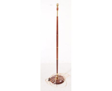 British Modern Design - A mid 20th century teak and brass floor standing standard lamp. The lamp stood on a round teak wood b