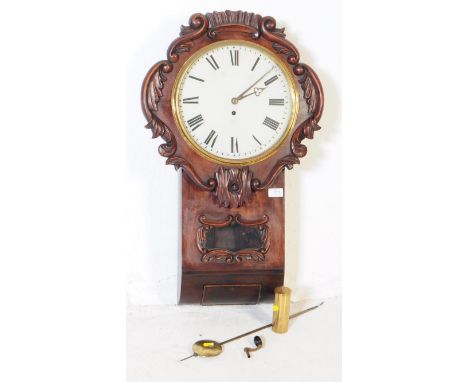 An English drop dial 24 hour movement wall clock. Carved design to outer with white face, roman numeral chapter ring and maho