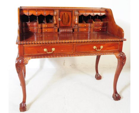 A Chippendale revival mahogany Carlton House manner desk. The desk raised on long carved cabriole legs, below a pair of brass