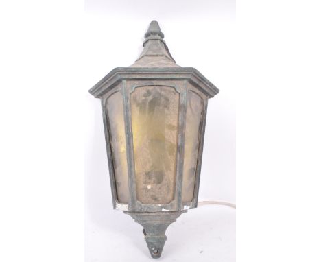 A large Victorian metal and glass 19th Century lantern wall light in the style of a street lamp, having a flat back with thre