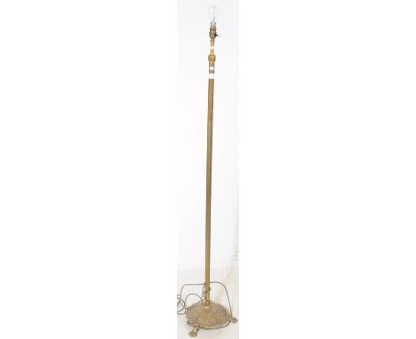A 19th century brass weighted floor standing standard lamp. The lamp raised on three paw feet, joined by a foliate relief bas