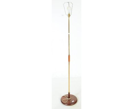 A vintage 20th century floor standing standard lamp light. Having metal and wood construction with a circular base and light 