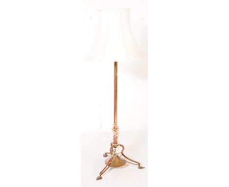 An early 19th century George III brass floor standing standard lamp. The lamp raised on a trio of splayed legs, each with sha