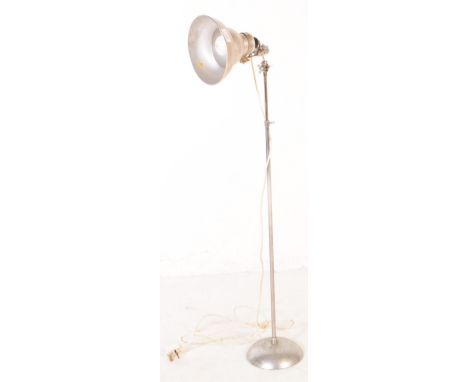 A 20th Century retro chrome metal industrial lamp light having conical dish shaped shade with adjustable stem body upon domed